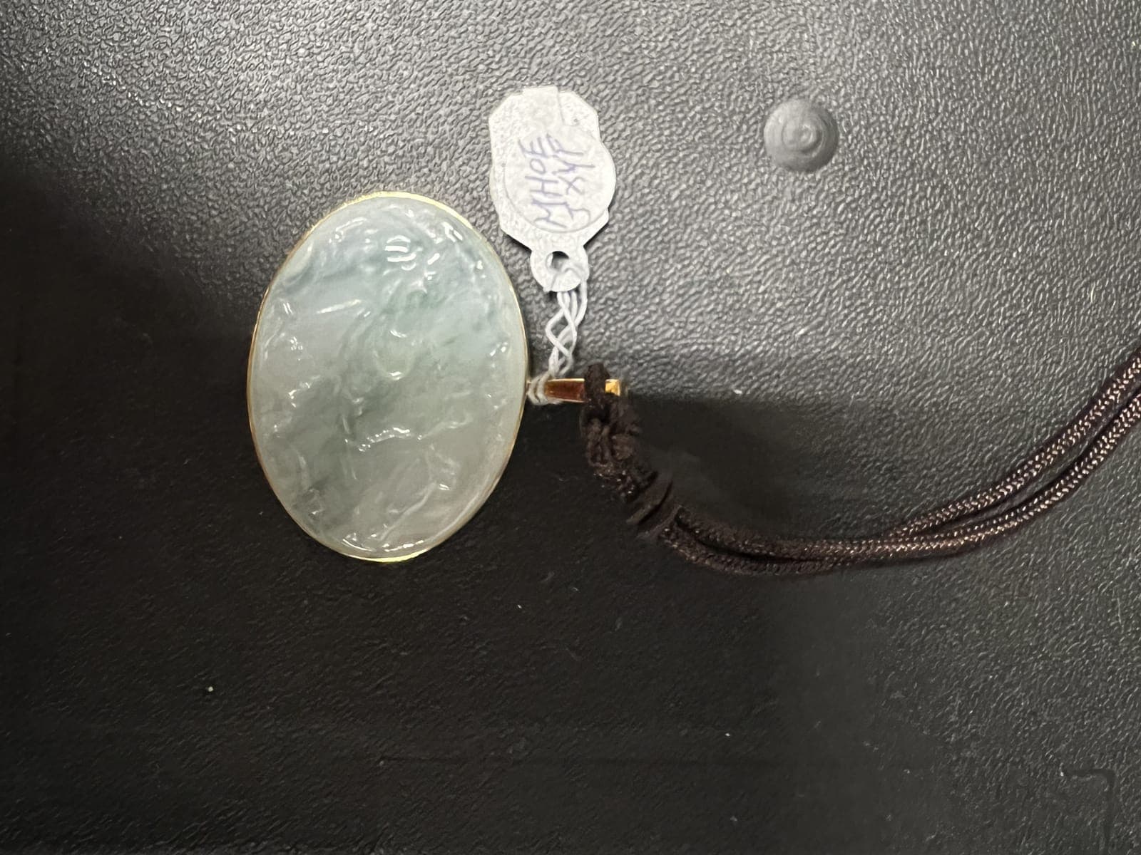 Carved Icy Jadeite Oval Pendant on Silk Cord